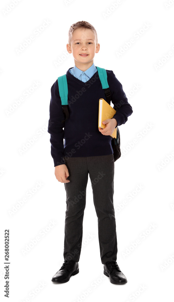 Full length portrait of cute boy in school uniform with book and backpack on white background Full length portrait of cute boy in school uniform with book and backpack on white background