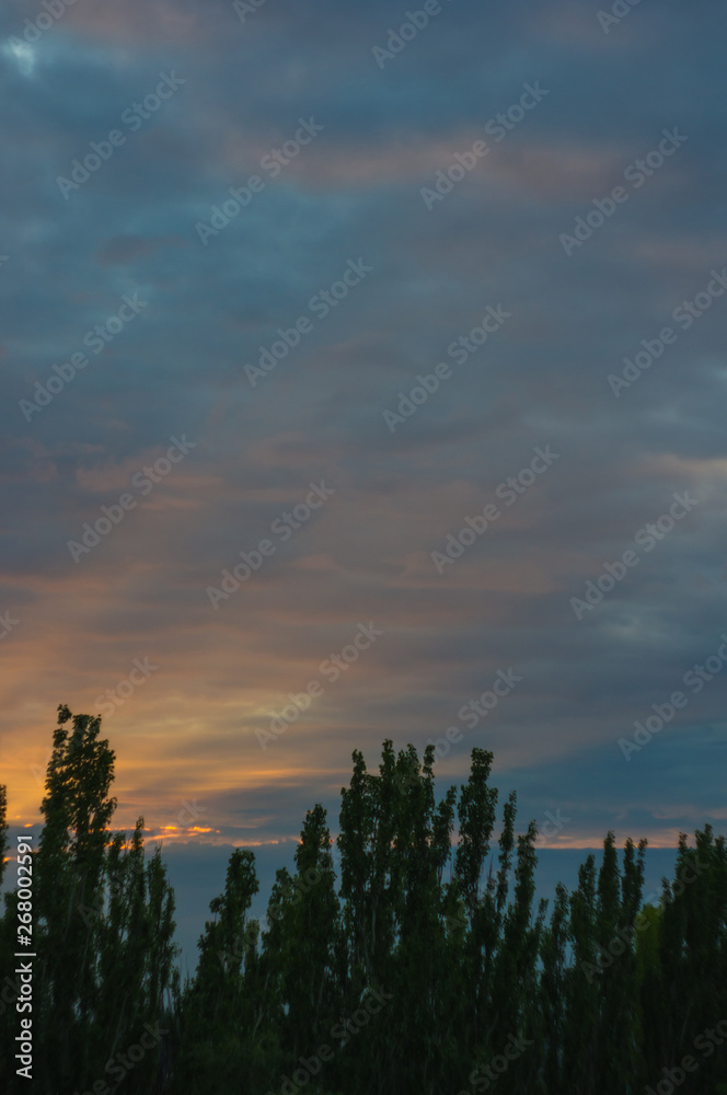 Landscape with dramatic light - beautiful golden sunset with saturated sky and clouds. Landscape with dramatic light - beautiful golden sunset with saturated sky and clouds.