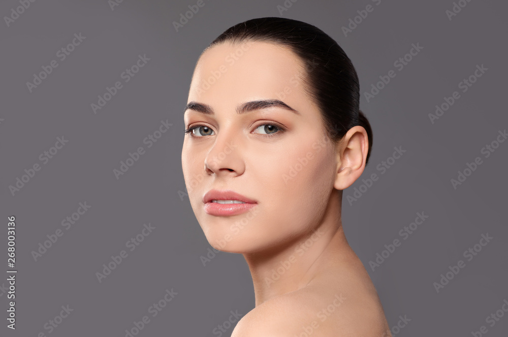 Portrait of young woman with beautiful face and natural makeup on color background Portrait of young woman with beautiful face and natural makeup on color background