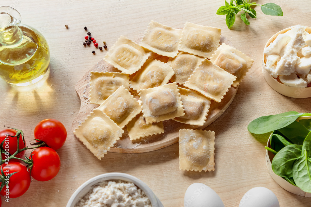 Top view healthy simple summer homemade food cooking raw vegetarian Italian pasta square ravioli with ingredients light flat lay Top view healthy simple summer homemade food cooking raw vegetarian Italian pasta square ravioli with ingredients light flat lay