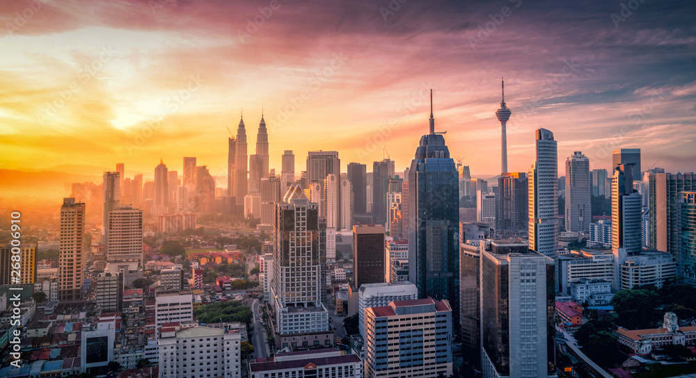 Naklejka premium Cityscape of Kuala lumpur city skyline with swimming pool on the roof top of hotel at sunrise in Malaysia.