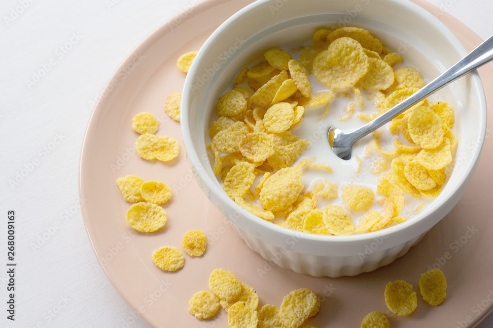 Healthy breakfast with cornflakes and milk over white background Healthy breakfast with cornflakes and milk over white background