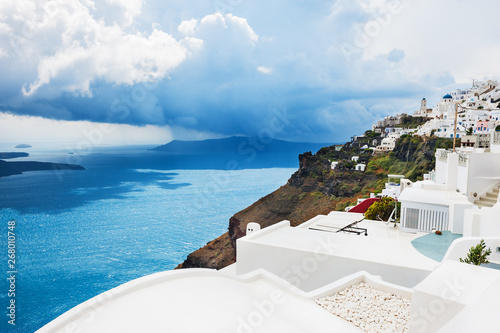 Rainy clouds over Santorini island, Greece. Summer landscape with sea view