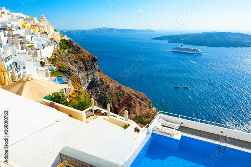 Panoramic view of Santorini island, Greece. Luxury swimming pool with sea view. Famous travel destination