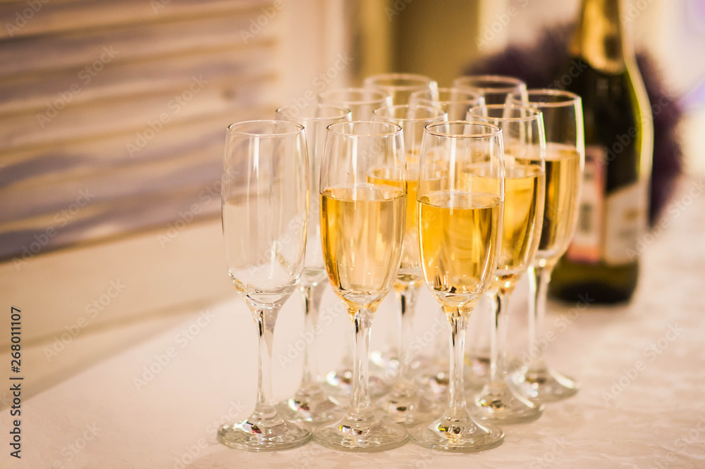 some glasses of champagne with a bottle on the background some glasses of champagne with a bottle on the background