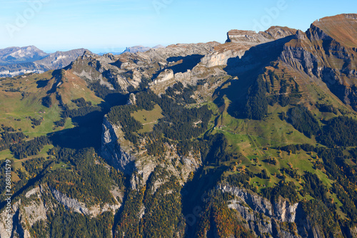 Mountains panorama with the autumn trees on the hillsides in the morning in Lauterbrunnen region in Switzerland.