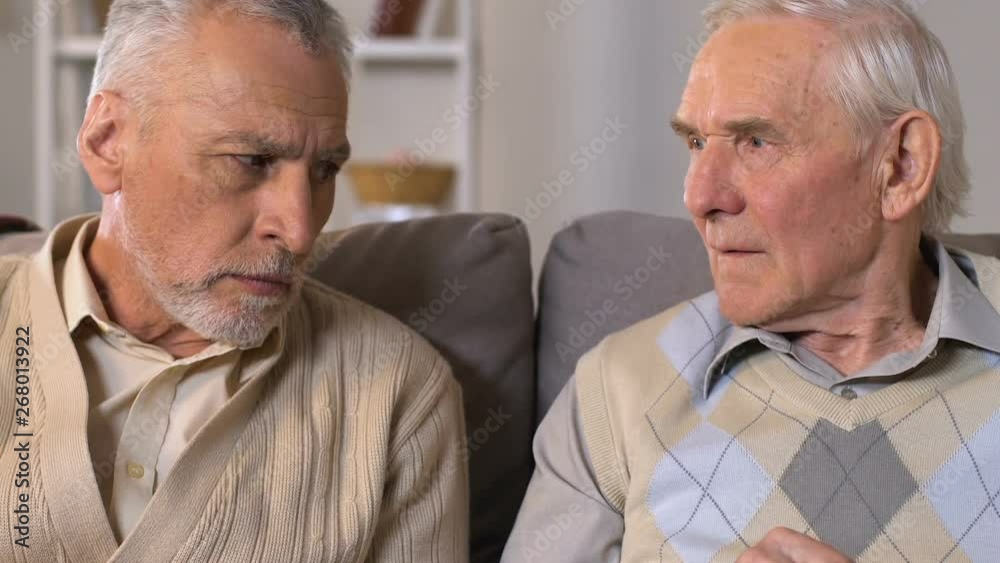 Two retired men counting coins in hands, pension poverty, financial crisis Two retired men counting coins in hands, pension poverty, financial crisis
