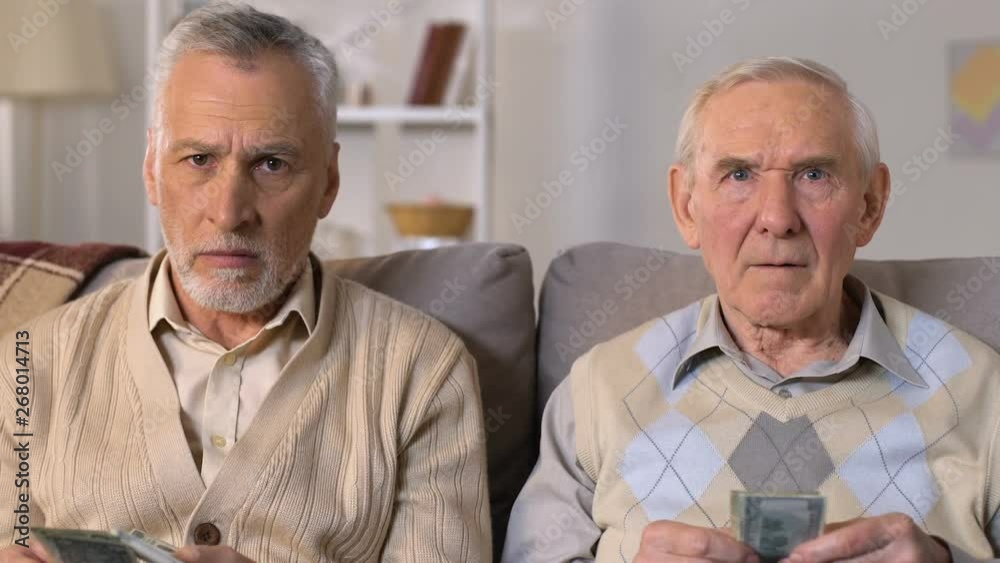 Poor retired men counting money looking sadly in camera, pension age increase Poor retired men counting money looking sadly in camera, pension age increase