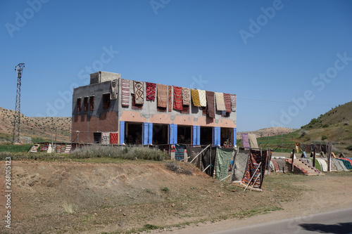 Colorful woven carpets hanging on a house front in a Berber Village in the Atlas Mountains, near Marrakesh, Morocco