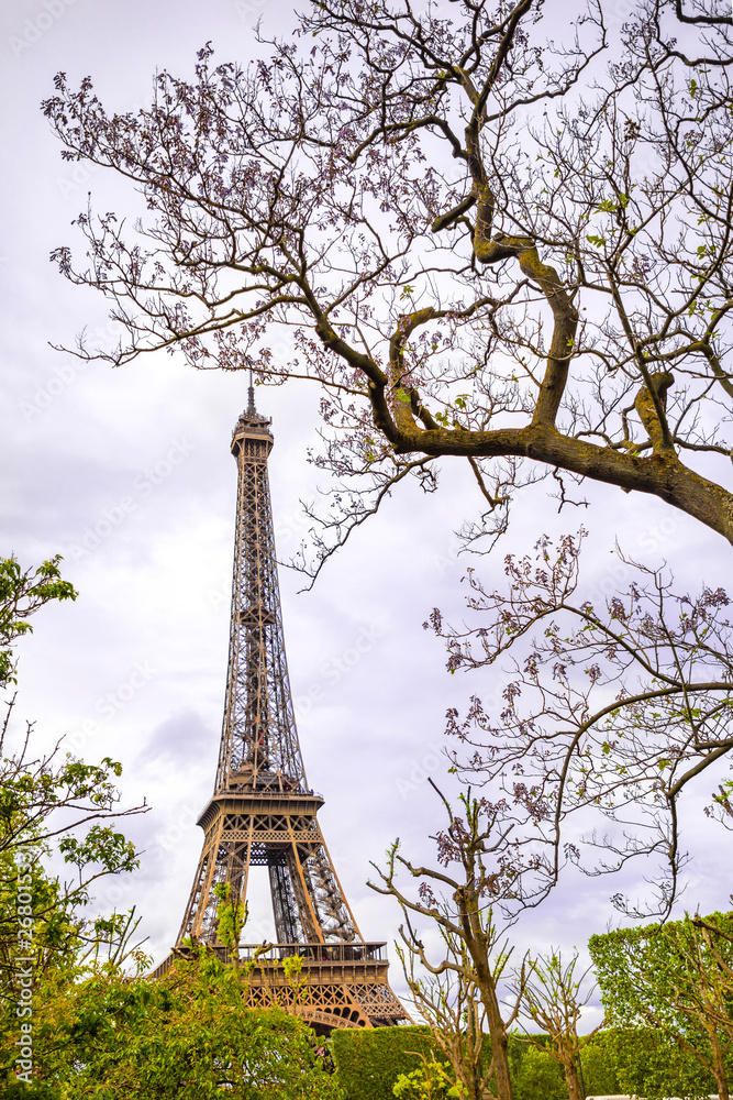 View from the bottom of The Eiffel Tower in Paris in cloudy day, France