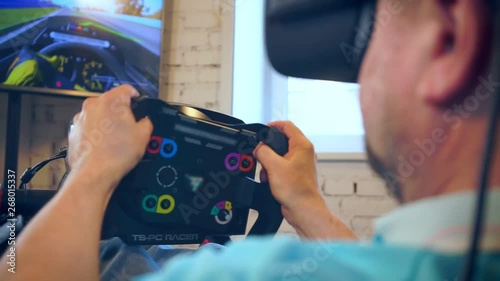 mature man takes part in car racing with high-tech simulator