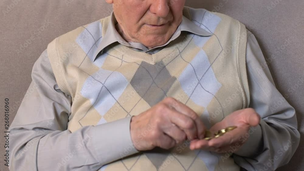 Old man counting coins hand looking camera, pension fund, poverty hopelessness Old man counting coins hand looking camera, pension fund, poverty hopelessness