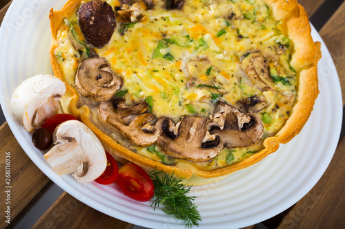 Delicious french quiche  cooked with cheese and mushrooms