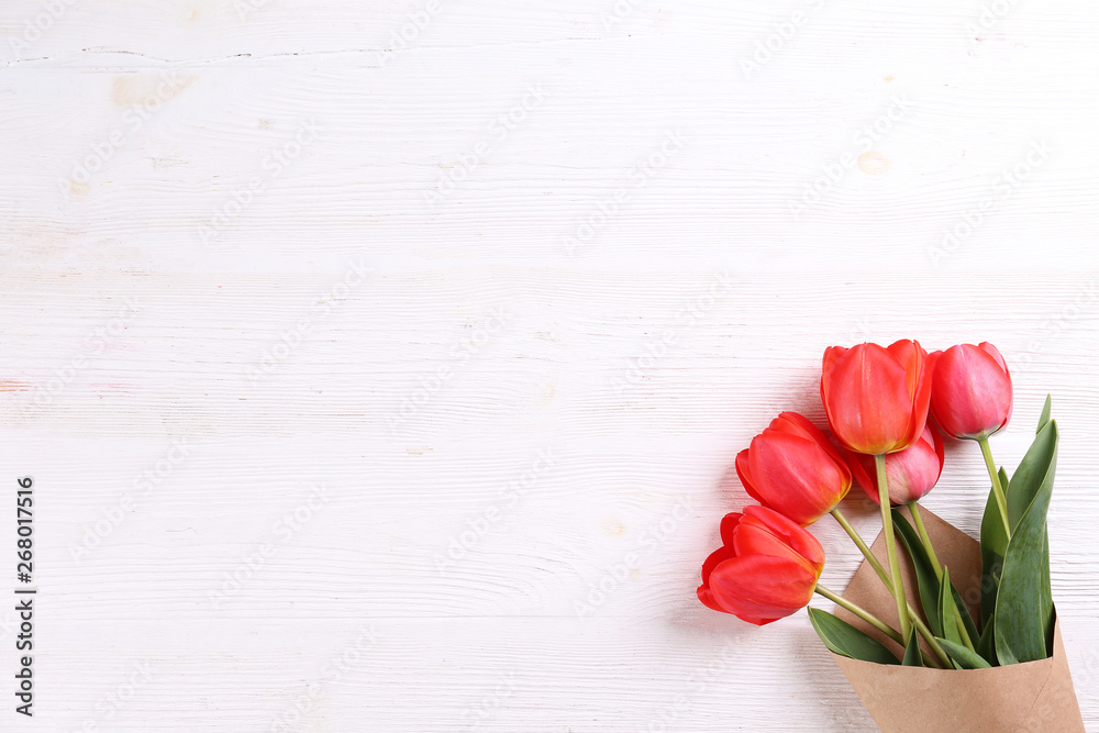 Fresh flower composition, bouquet of red color tulips, textured background. International Women's day, mother's day greeting concept. Copy space, close up, top view, flat lay.