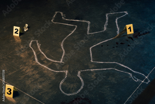 chalk outline and evidence markers at crime scene photo