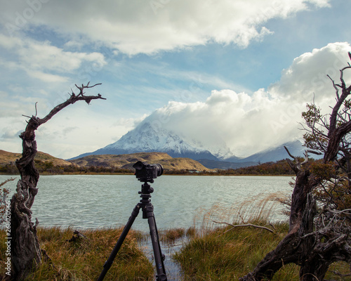 Explora Viewpoint in Chile Patagonia Torres del Plaine.  With lake, mountain peak, and a tripod and camera © JMP Traveler