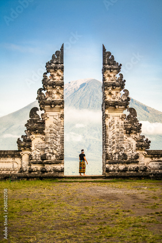 man standing between concrete ruins during daytime photo