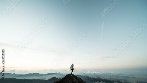 man standing on top of a mountain photo