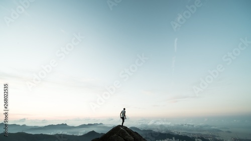man standing on top of a mountain
