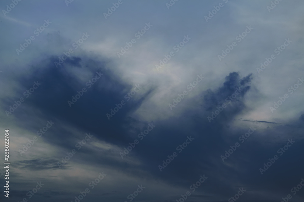 The sky with dark clouds illuminated by the setting sun The sky with dark clouds illuminated by the setting sun