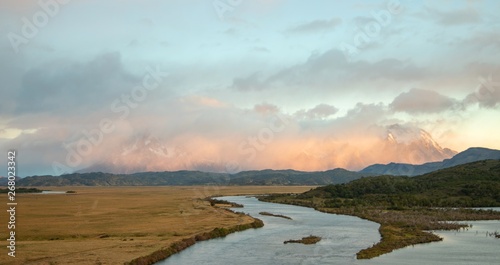 View of Mountains, grass meadow, and river during sunrise in Patagonia Chile, Torres del Paine 