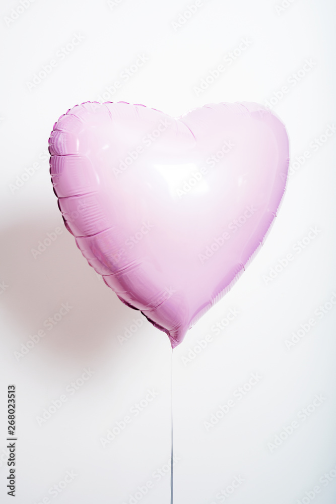 Set of balloons in the form of a heart and round pink and striped on light background with copy space. Set of balloons in the form of a heart and round pink and striped on light background with copy space.