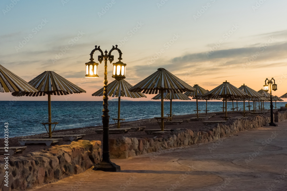 Abandoned empty street, sea and old lamp in Dahab resort Egypt Abandoned empty street, sea and old lamp in Dahab resort Egypt