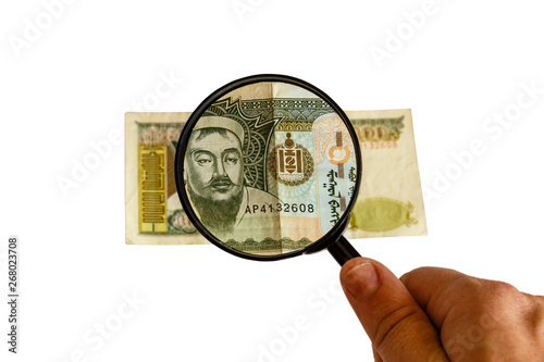 five hundred Mongolian tugriks bill and magnifying glass in hand isolated on white background, obverse front side photo