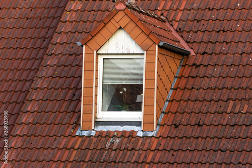 Attic window on the tiled roof.