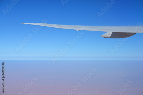 blue sky and wing of plane