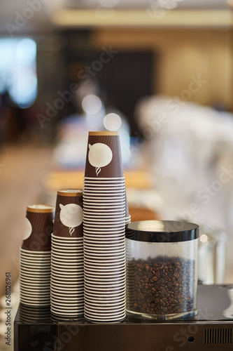 Disposable cardboard cups for coffee. Coffee machine