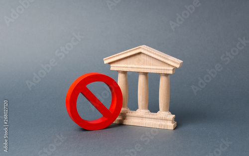 Government building or bank and symbol NO on an gray background. The concept of prohibiting and restrictive laws. Bans and criminalization, repression. Revocation of a bank license nationalization photo