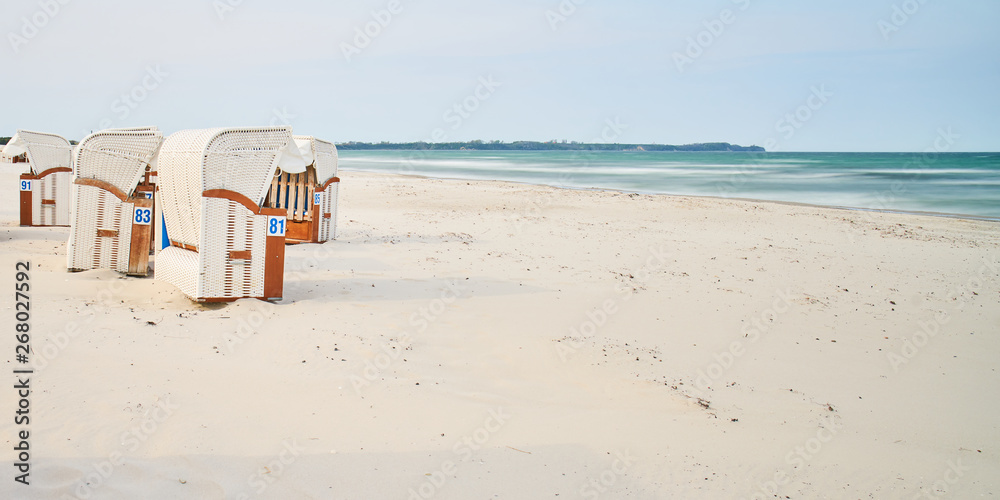 Wooden beach chairs, white sand beach, Rugen Island, Germany                               