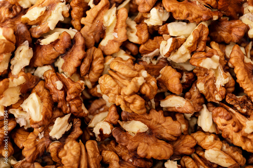 Closeup of big shelled walnuts pile. Natural walnut background pattern texture.