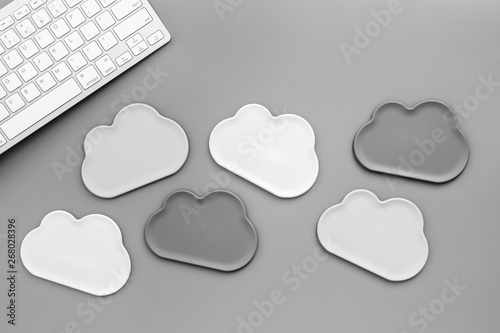 Cloud figures and keyboard for cloud storage on gray background top view