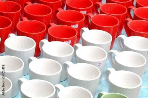 A pile of red white coffee mugs on the ground floor at the wholesale market 