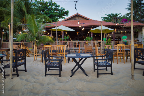 Phu Quoc  Vietnam - March 27  2019  table and chairs in front of the beach restaurant with waiters in background