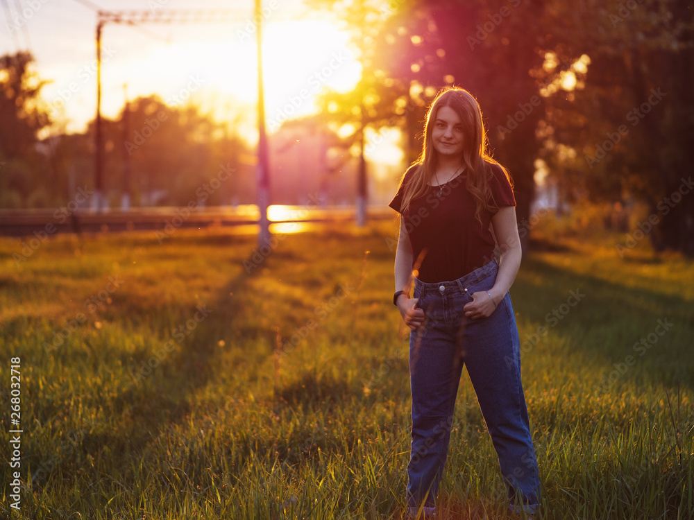 Beautiful stylish young woman at sunset Beautiful stylish young woman at sunset