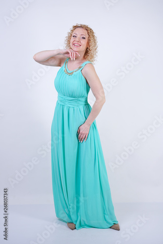 pretty blonde caucasian woman wearing long blue fashion summer dress on white background
