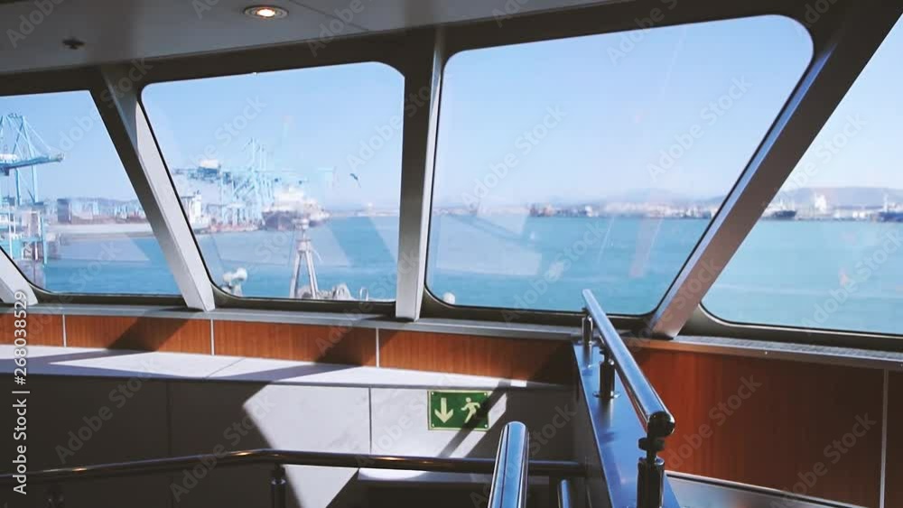 Algeciras, Spain view from inside ferryboat leaving Spanish goods and passenger port towards Ceuta with Gibraltar industrial cargo port and mountains on the horizon VHS tape film Algeciras, Spain view from inside ferryboat leaving Spanish goods and passenger port towards Ceuta with Gibraltar industrial cargo port and mountains on the horizon VHS tape film