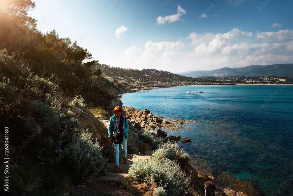 Fototapeta premium Woman walking with dog on path on hill at the Cote d'Azur