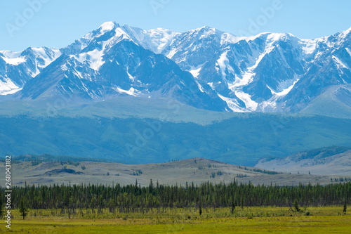 Snow capped mountains and hills with pine trees in Altai Republic, Russia photo