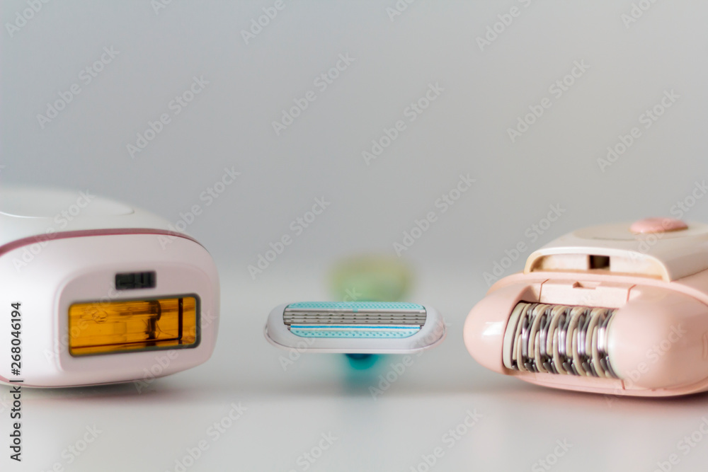 Razor, epilator and IPL epilator on white background. Hair removal concept Razor, epilator and IPL epilator on white background. Hair removal concept