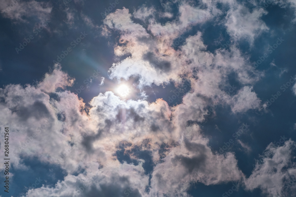 Sunbeam through the haze on blue sky , clouds with sun rays Sunbeam through the haze on blue sky , clouds with sun rays
