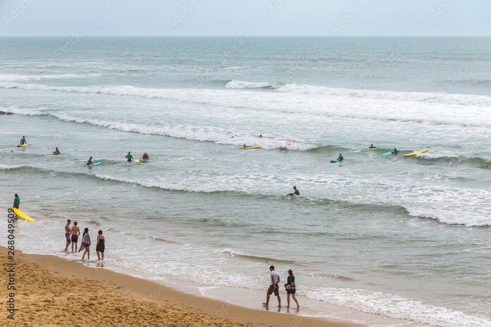 Unrecognisable surfers enjoy waves in the water of Atlantic ocean on the coast near Lacanau-Ocean, Bordeaux, France Unrecognisable surfers enjoy waves in the water of Atlantic ocean on the coast near Lacanau-Ocean, Bordeaux, France