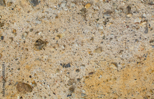 Earth texture. Pebbles in the ground. Beige background