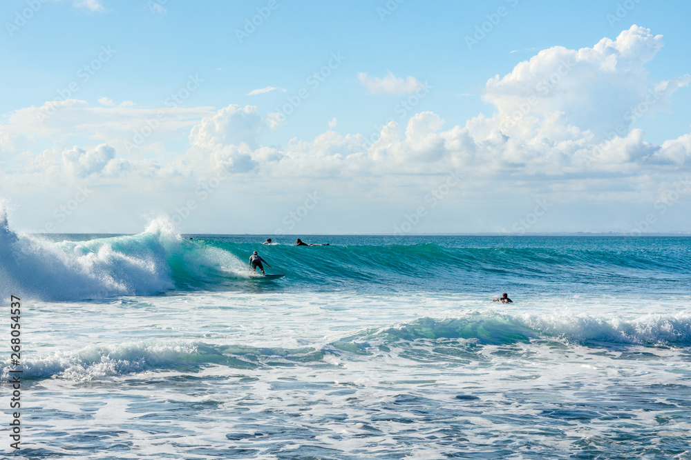 Obraz premium 5 May 2019 : Balangan Beach, Bali, Indonesia - Man riding wave on a sunny summers day.
