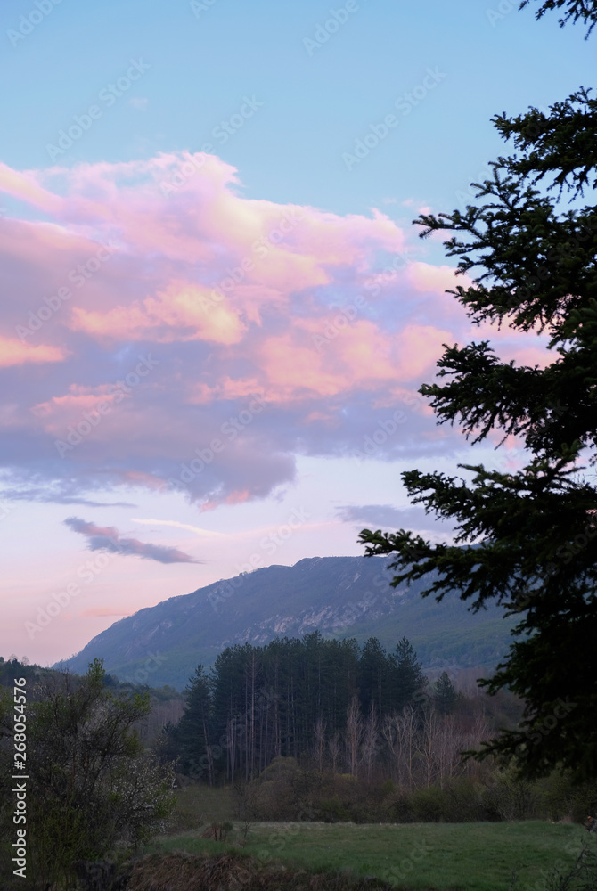 Sunset in the mountains, pink clouds and forests Sunset in the mountains, pink clouds and forests