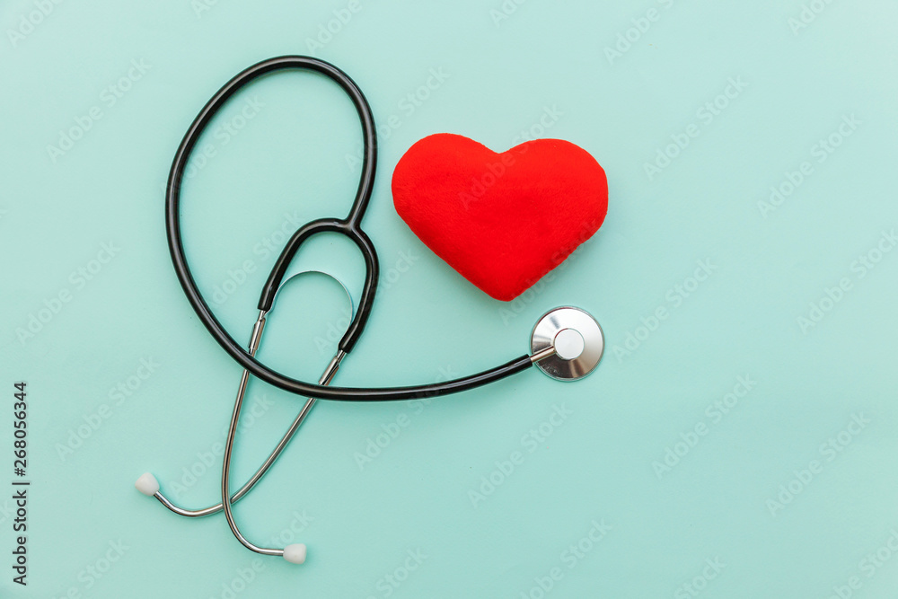 Simply minimal design with medicine equipment stethoscope or phonendoscope and red heart isolated on trendy pastel blue background. Instrument device for doctor. Health care life insurance concept Simply minimal design with medicine equipment stethoscope or phonendoscope and red heart isolated on trendy pastel blue background. Instrument device for doctor. Health care life insurance concept