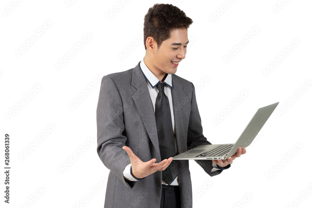 Happy young businessman standing hold laptop in suit on white background, isolated concept Happy young businessman standing hold laptop in suit on white background, isolated concept